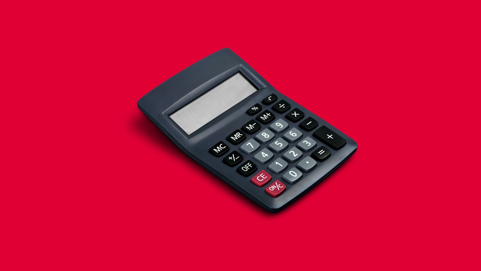 calculadora antigua sobre un fondo rojo