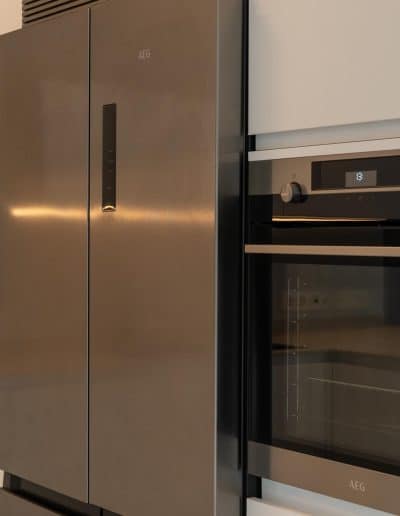 un frente con electrodomésticos de una cocina moderna abierta y con península